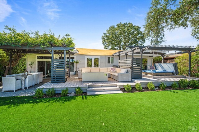 rear view of house featuring an outdoor hangout area, a pergola, a lawn, and a wooden deck