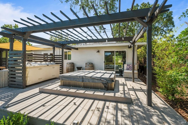 view of patio with a covered hot tub, a deck, and a pergola