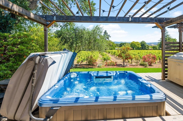 view of swimming pool featuring a pergola, a wooden deck, and an outdoor hot tub