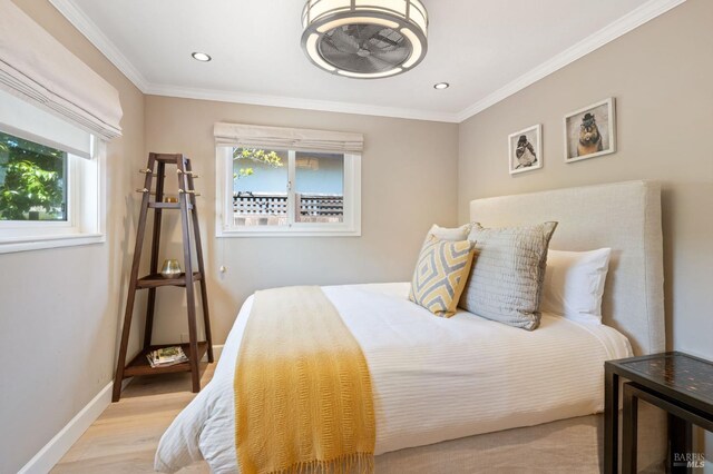 bedroom featuring light wood-type flooring, recessed lighting, baseboards, and crown molding