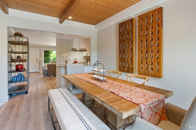 dining room with light wood-type flooring, beamed ceiling, wooden ceiling, and recessed lighting