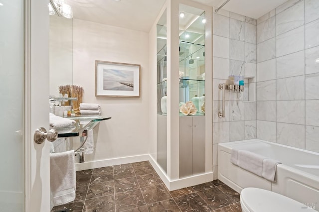 full bathroom with marble finish floor, bathing tub / shower combination, toilet, and baseboards