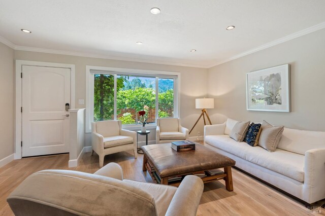 living area with crown molding, recessed lighting, baseboards, and light wood-style floors