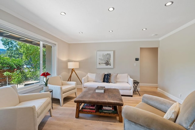 living room with a healthy amount of sunlight, light wood-type flooring, and crown molding