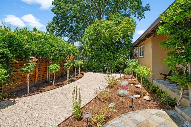view of yard with fence and a patio