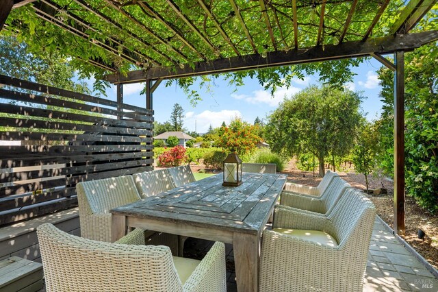 view of patio / terrace with a pergola and outdoor dining space
