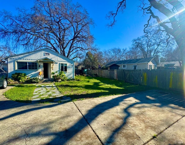 view of yard with fence and driveway