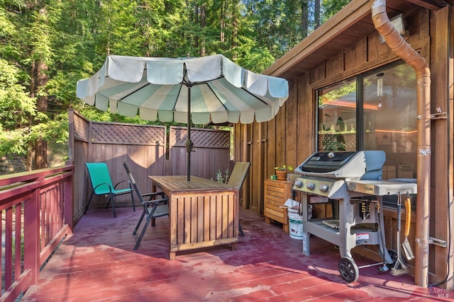 view of patio featuring a deck, outdoor dining space, and a grill
