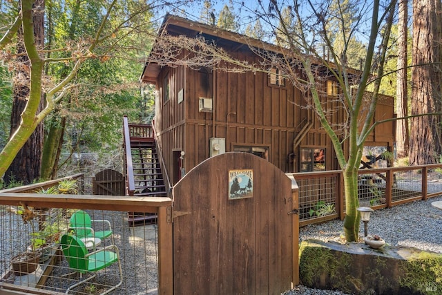 view of jungle gym with a gate, fence private yard, and stairway