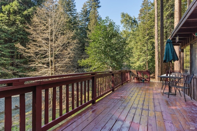 wooden terrace featuring outdoor dining area