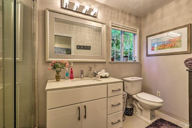 bathroom featuring vanity, a shower with shower door, and toilet