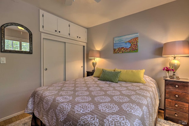 bedroom featuring hardwood / wood-style floors, a closet, and ceiling fan