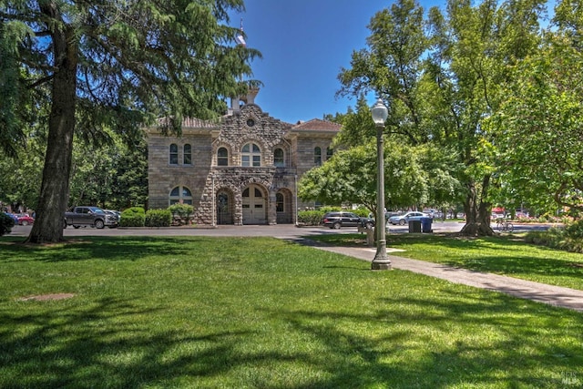 mediterranean / spanish-style house featuring a front lawn