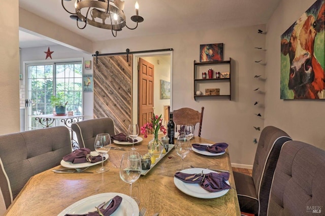 dining area with a barn door and a notable chandelier