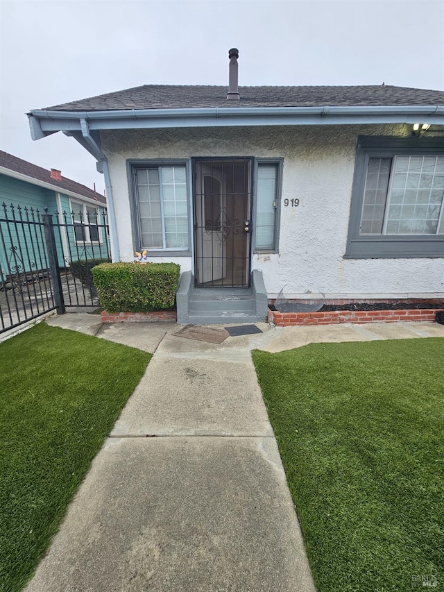 property entrance with a yard