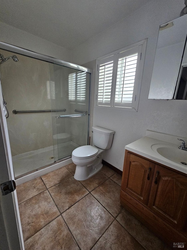 bathroom featuring vanity, an enclosed shower, tile patterned floors, and toilet