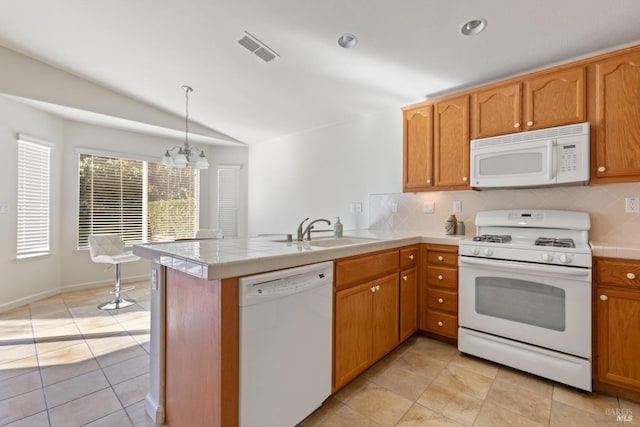 kitchen with vaulted ceiling, kitchen peninsula, sink, white appliances, and a chandelier