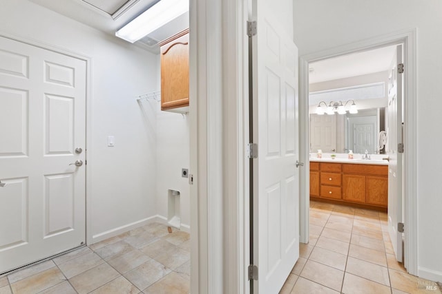 corridor featuring light tile patterned floors and sink