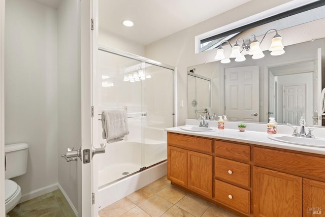 bathroom featuring tile patterned floors, toilet, vanity, and an enclosed shower