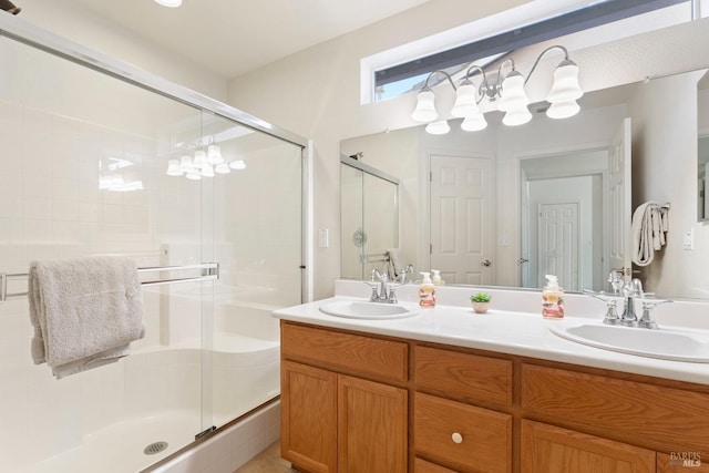 bathroom with vanity and a shower with door