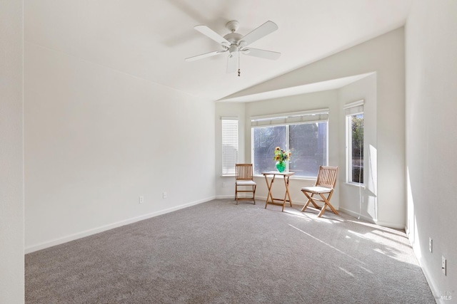 unfurnished room featuring ceiling fan, vaulted ceiling, and carpet flooring