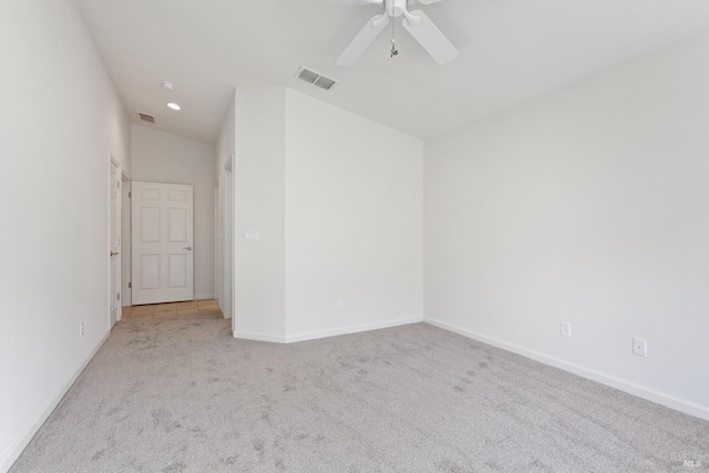 carpeted spare room with ceiling fan