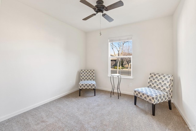 sitting room featuring ceiling fan and carpet