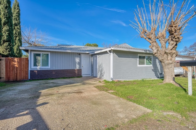 ranch-style house with a front lawn