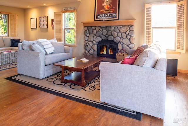40695 Roseman Creek Rd, Gualala, CA 95445 - living area featuring hardwood / wood-style floors, plenty of natural light, a stone fireplace, and recessed lighting