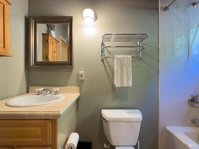 full bathroom with toilet, tiled shower / bath combo, and vanity