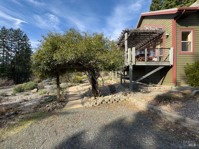 view of yard with a pergola and a deck