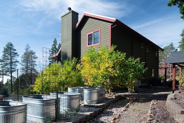 40695 Roseman Creek Rd, Gualala, CA 95445 - view of property exterior with a chimney and a hot tub