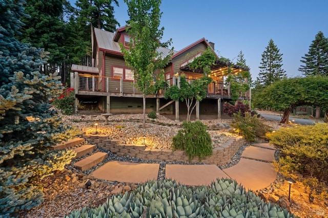 40695 Roseman Creek Rd, Gualala, CA 95445 - rear view of house featuring a wooden deck, metal roof, and a chimney
