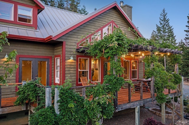 40695 Roseman Creek Rd, Gualala, CA 95445 - view of front of property with a chimney, metal roof, a standing seam roof, and a deck