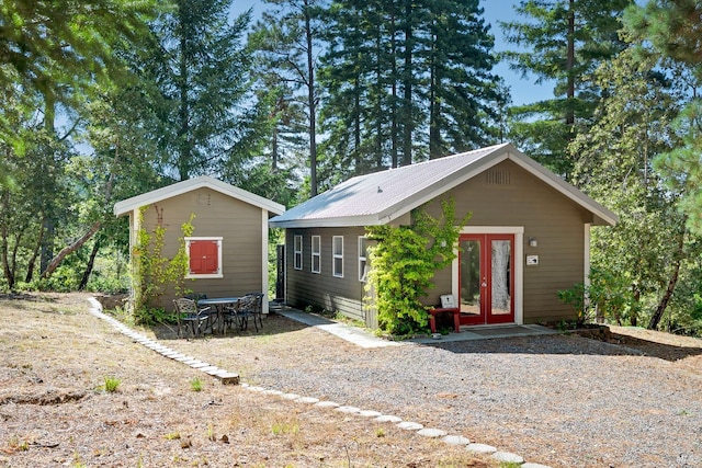 40695 Roseman Creek Rd, Gualala, CA 95445 - view of front facade with french doors and metal roof