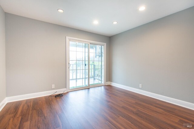 empty room featuring dark hardwood / wood-style flooring