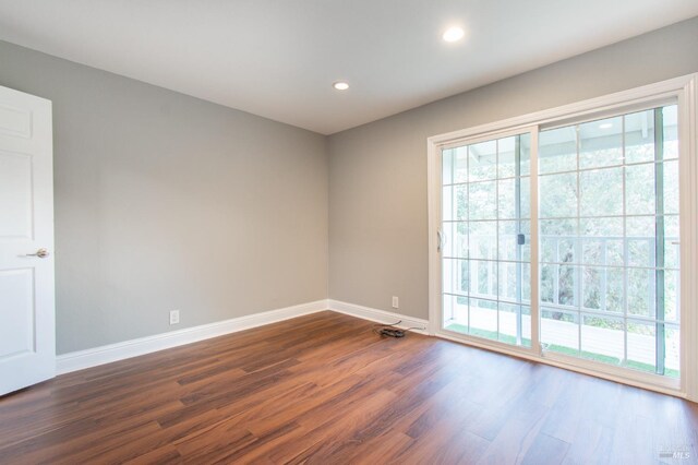 spare room with dark hardwood / wood-style flooring