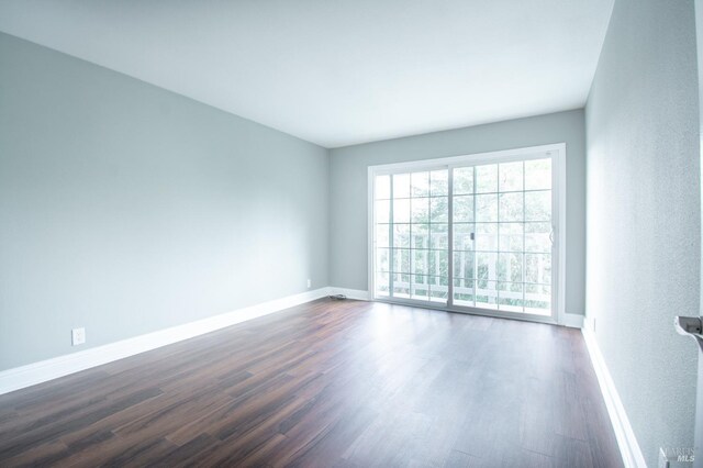 empty room featuring dark hardwood / wood-style flooring