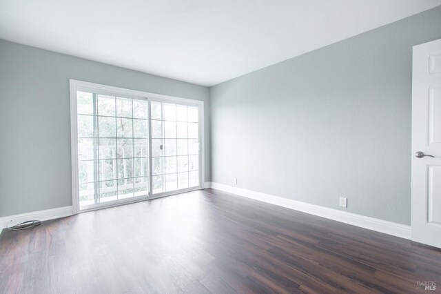 empty room featuring dark wood-type flooring