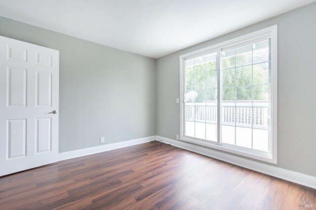 spare room featuring dark hardwood / wood-style floors