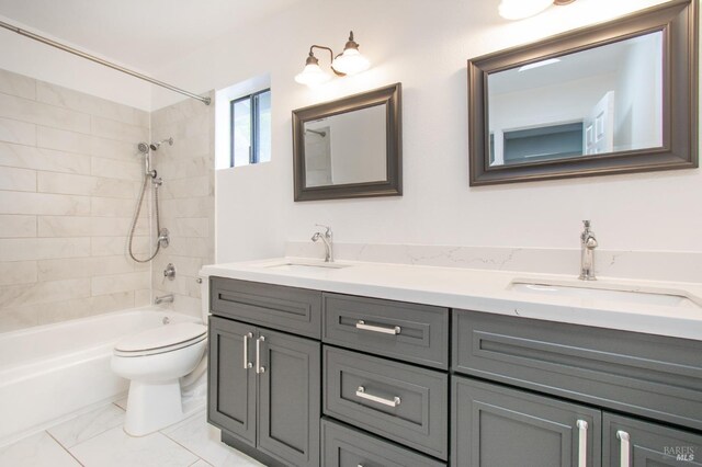 full bathroom with tiled shower / bath combo, vanity, and toilet