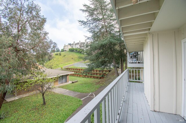 wooden terrace with a yard