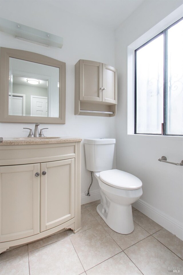 bathroom with vanity, tile patterned flooring, and toilet