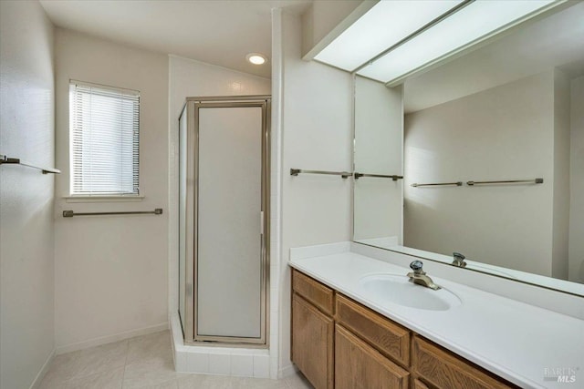 full bath featuring a shower stall, baseboards, tile patterned flooring, and vanity