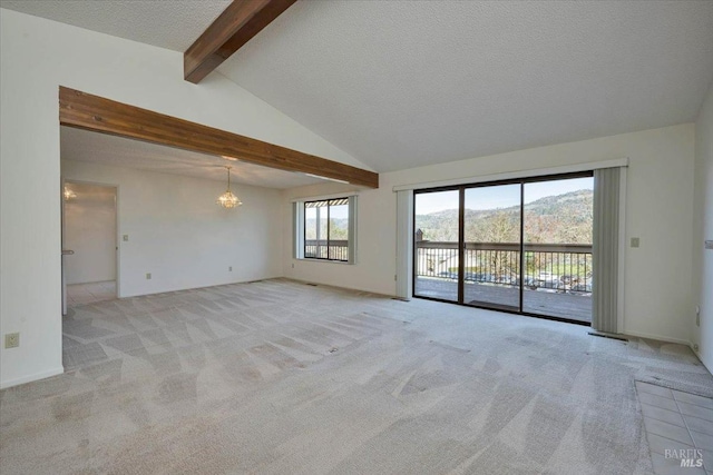 spare room with vaulted ceiling with beams, a textured ceiling, a chandelier, light colored carpet, and baseboards