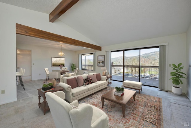 living area featuring light carpet, lofted ceiling with beams, a textured ceiling, and an inviting chandelier