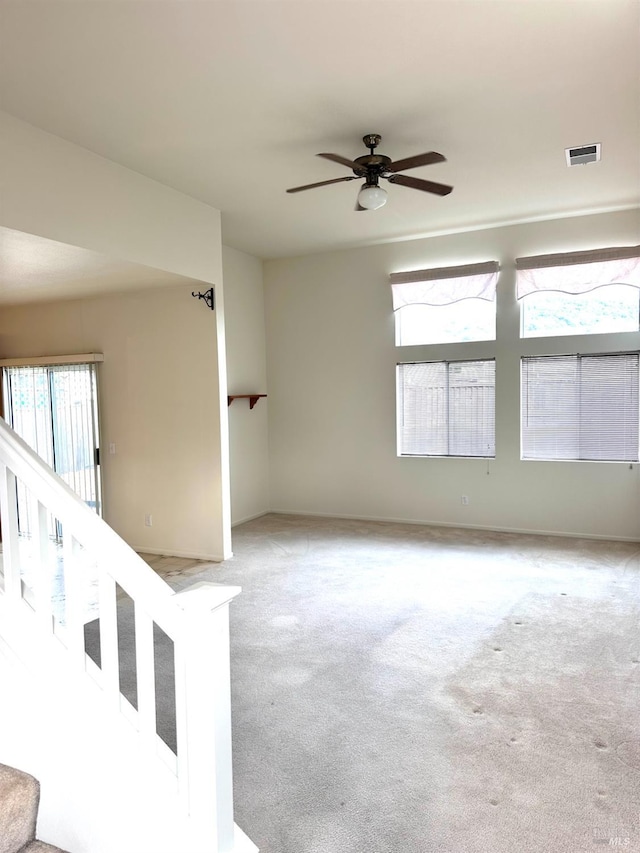 carpeted spare room with ceiling fan