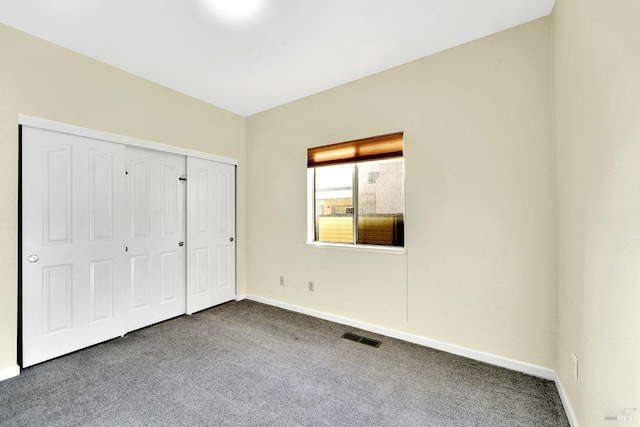 unfurnished bedroom featuring carpet floors and a closet