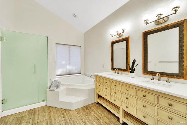 bathroom featuring shower with separate bathtub, vanity, and lofted ceiling