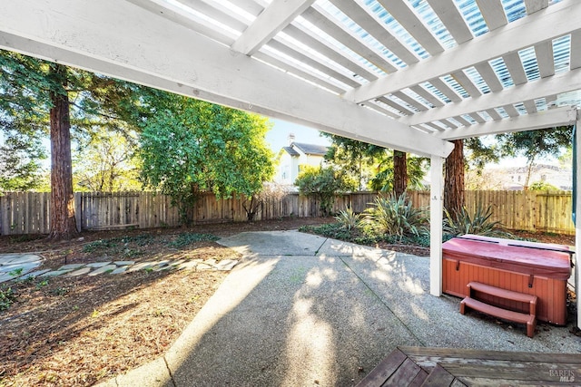 view of patio / terrace featuring a pergola and a hot tub